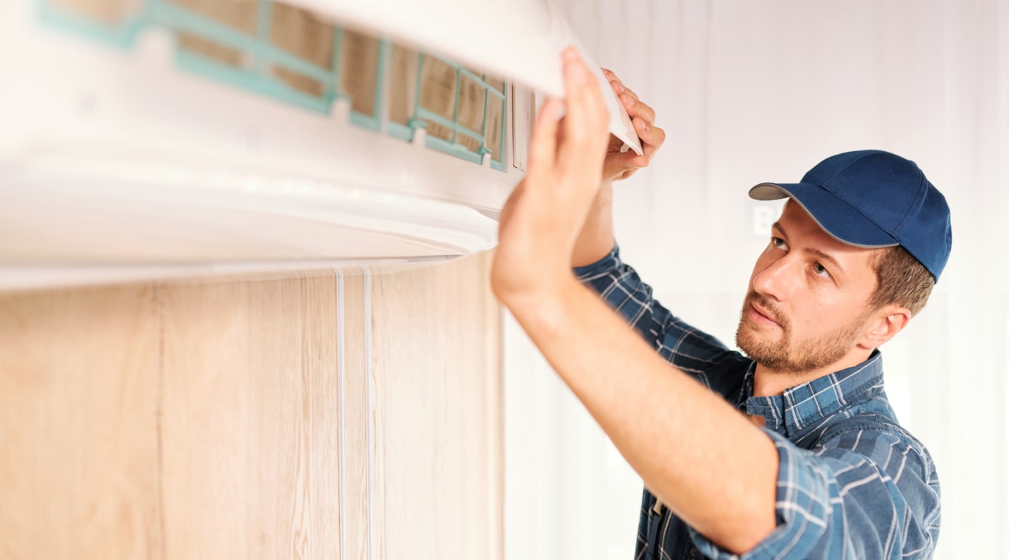 On Point Air technician servicing an air conditioning unit